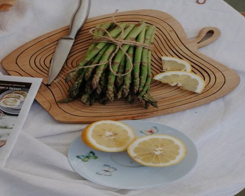 A bundle of fresh sukuma wiki on a wooden cutting board